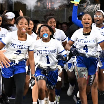 With the same excitement and flash usually reserved for the NFL's Baltimore Ravens, the Patterson girls flag football team races from the tunnel at M&T Bank Stadium in Baltimore to compete in the state championship event hosted by the Ravens.