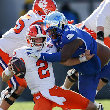 Dec 29, 2023; Jacksonville, FL, USA;  Clemson Tigers quarterback Cade Klubnik (2) is brought down by Kentucky Wildcats defensive lineman Deone Walker (0) in the third quarter during the Gator Bowl at EverBank Stadium