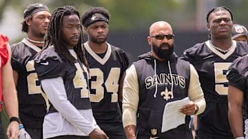 Jun 10, 2025; New Orleans, LA, USA;  New Orleans Saints running back Alvin Kamara (41) talks with New Orleans Saints running backs coach Joel Thomas during minicamp at Ochsner Sports Performance Center. Mandatory Credit: Stephen Lew-Imagn Images