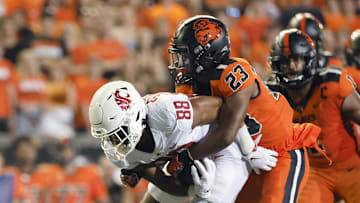 Oct 15, 2022; Corvallis, Oregon, USA; Washington State Cougars wide receiver De'Zhaun Stribling (88) is brought down by Oregon State Beavers defensive back Ryan Cooper Jr. (23) during the first half at Reser Stadium. Mandatory Credit: Soobum Im-Imagn Images