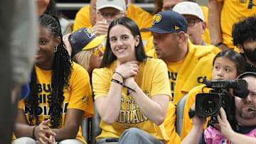 Caitlin Clark does the choke celebration early in Game 3 of the NBA Finals.