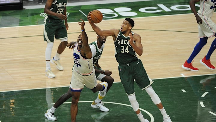 Milwaukee Bucks forward Giannis Antetokounmpo grabs a rebound in front of Philadelphia 76ers center Dwight Howard. Milwaukee Bucks forward Giannis Antetokounmpo grabs a rebound in front of Philadelphia 76ers center Dwight Howard.