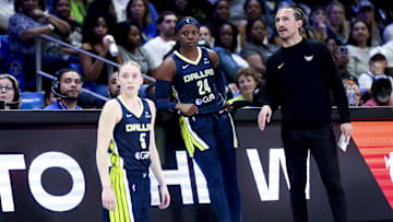 May 16, 2025; Arlington, Texas, USA;  Dallas Wings guard Paige Bueckers (5) and Dallas Wings guard Arike Ogunbowale (24) and Dallas Wings head coach Chris Koclanes talk against the Minnesota Lynx during the first half at College Park Center. Mandatory Credit: Kevin Jairaj-Imagn Images