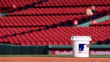 Jun 28, 2024; Boston, Massachusetts, USA;    A bucket of baseballs sits on the grass before a game between the Boston Red Sox and the San Diego Padres at Fenway Park. Mandatory Credit: Eric Canha-Imagn Images