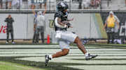 Nov 2, 2024; Orlando, Florida, USA; UCF Knights running back RJ Harvey (7) scores a touchdown against the Arizona Wildcats during the first quarter at FBC Mortgage Stadium. Mandatory Credit: Mike Watters-Imagn Images