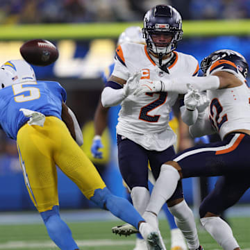 December 19, 2024, Inglewood, California, USA: Denver Broncos safety BRANDON JONES (22) and cornerback PATRICK SURTAIN II (2) challenge a catch attempt from Los Angeles Chargers wide receiver JOSH PALMER (5) during a NFL, American Football Herren, USA football game between the Denver Broncos and the Los Angeles Chargers at SoFi Stadium in Inglewood, California.
