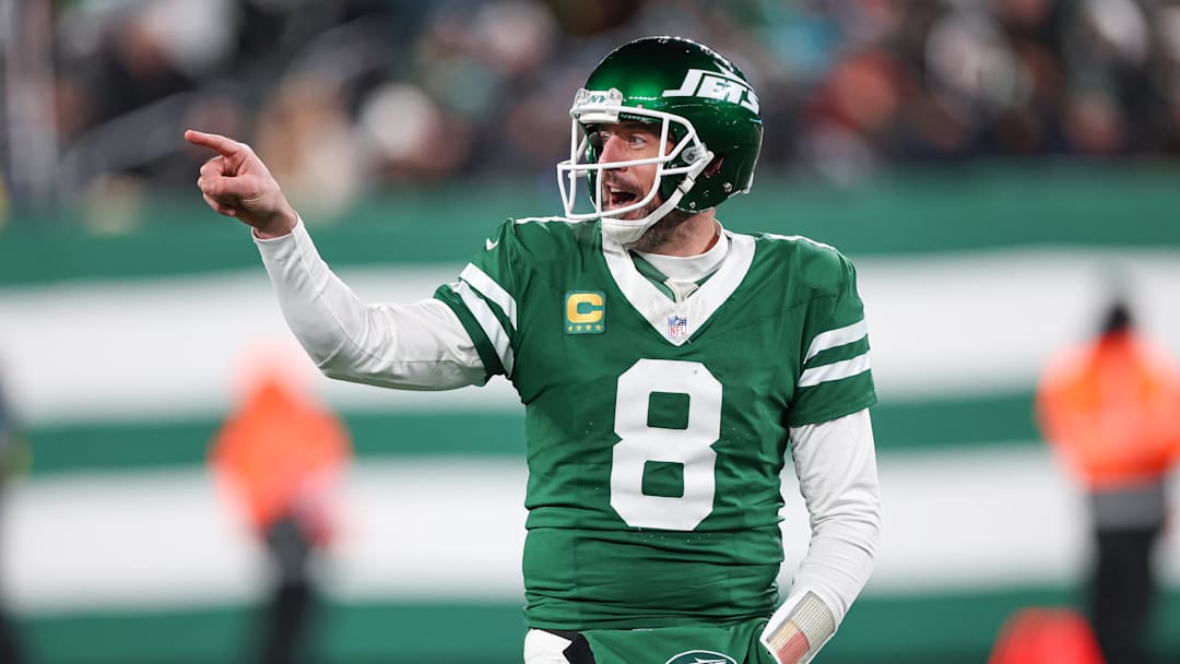New York Jets quarterback Aaron Rodgers (8) gestures towards the Miami Dolphins bench during the second half at MetLife Stadium.