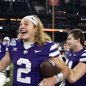 Dec 26, 2024; Phoenix, AZ, USA; Kansas State Wildcats quarterback Avery Johnson (2) celebrates after defeating the Rutgers Scarlet Knights during the Rate Bowl at Chase Field. Mandatory Credit: Mark J. Rebilas-Imagn Images