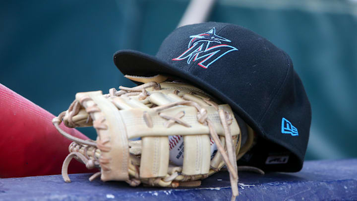 Apr 24, 2024; Atlanta, Georgia, USA; A detailed view of a Miami Marlins hat and glove in the dugout before a game against the Atlanta Braves at Truist Park. Mandatory Credit: Brett Davis-Imagn Images Apr 24, 2024; Atlanta, Georgia, USA; A detailed view of a Miami Marlins hat and glove in the dugout before a game against the Atlanta Braves at Truist Park. Mandatory Credit: Brett Davis-Imagn Images