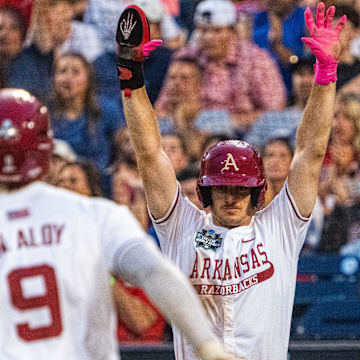 Arkansas Razorbacks third baseman Brent Iredale (10) celebrates as shortstop Wehiwa Aloy (9) scores on a two RBI double by right fielder Logan Maxwell (22) against the UCLA Bruins during the seventh inning at Charles Schwab Field. 