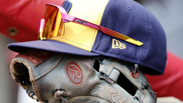 Jul 16, 2023; Cincinnati, Ohio, USA; The hat and glove of Milwaukee Brewers shortstop Willy Adames (27) sits in the dugout during a game against the Cincinnati Reds at Great American Ball Park. Mandatory Credit: David Kohl-Imagn Images
