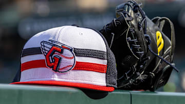 Jul 8, 2024; Detroit, Michigan, USA; A Cleveland Guardians baseball cap and glove sit on the dugout rail before the game against the Detroit Tigers at Comerica Park. Mandatory Credit: David Reginek-Imagn Images